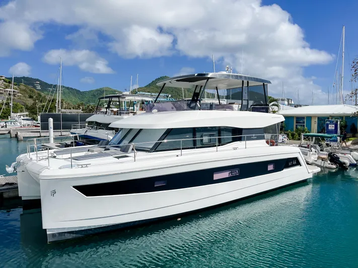 Wild Blue Yacht Photos Pics 2019 Fountaine Pajot MY 44 yacht docked in a scenic marina.
