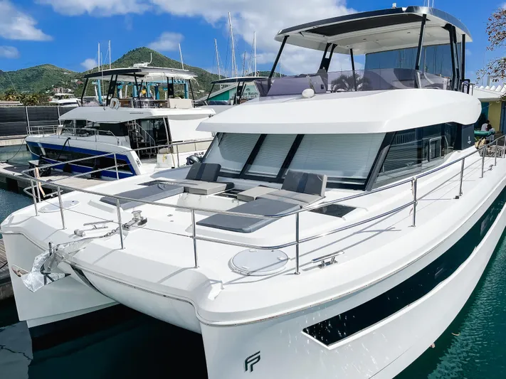 Wild Blue Yacht Photos Pics 2019 Fountaine Pajot MY 44 yacht docked in marina, featuring sleek design and spacious deck.