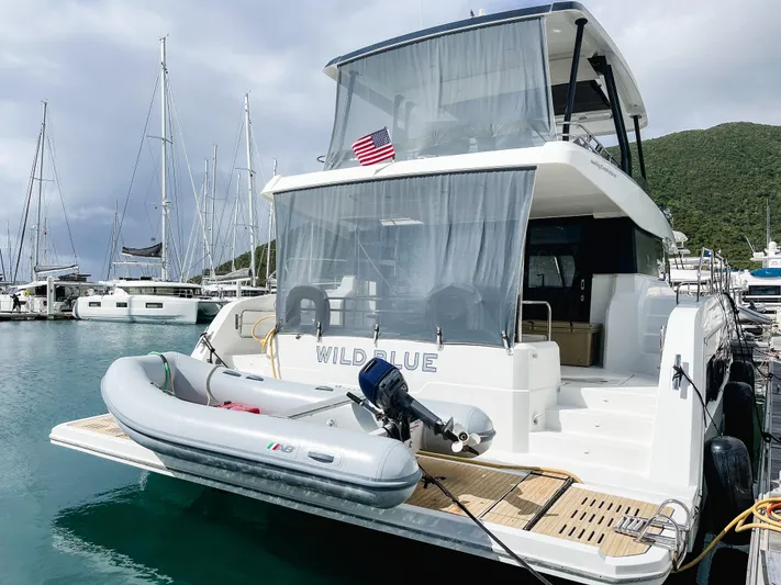 Wild Blue Yacht Photos Pics 2019 Fountaine Pajot MY 44 yacht docked with inflatable boat, marina background.