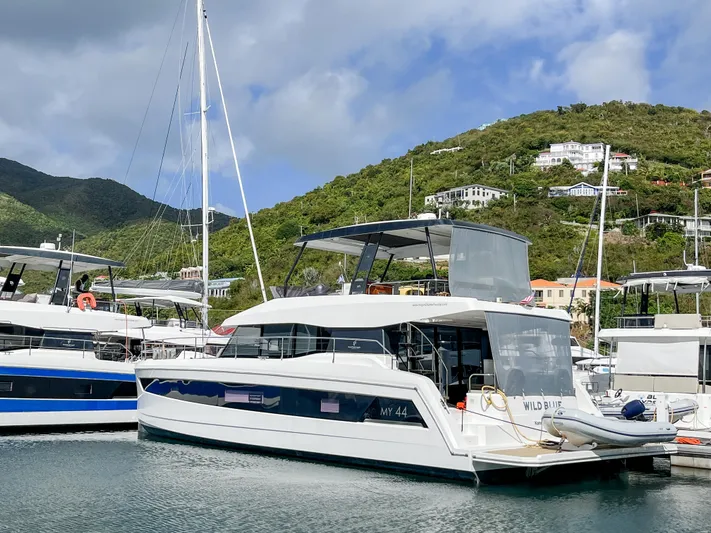 Wild Blue Yacht Photos Pics 2019 Fountaine Pajot MY 44 yacht docked in a scenic marina.