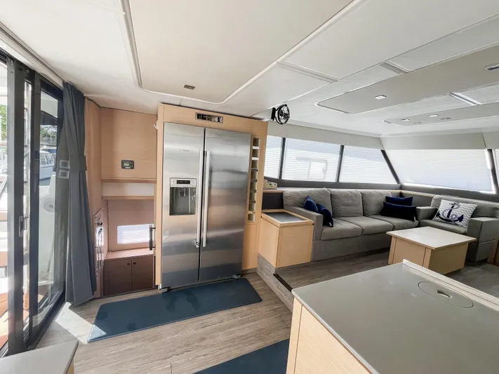 Wild Blue Yacht Photos Pics Luxurious interior of 2019 Fountaine Pajot MY 44 yacht with modern kitchen and seating area.