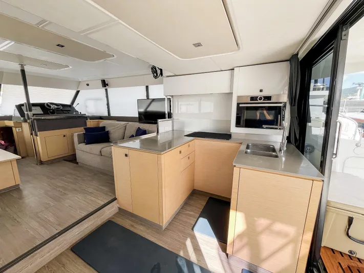Wild Blue Yacht Photos Pics Luxurious interior of 2019 Fountaine Pajot MY 44 yacht with modern kitchen and seating area.