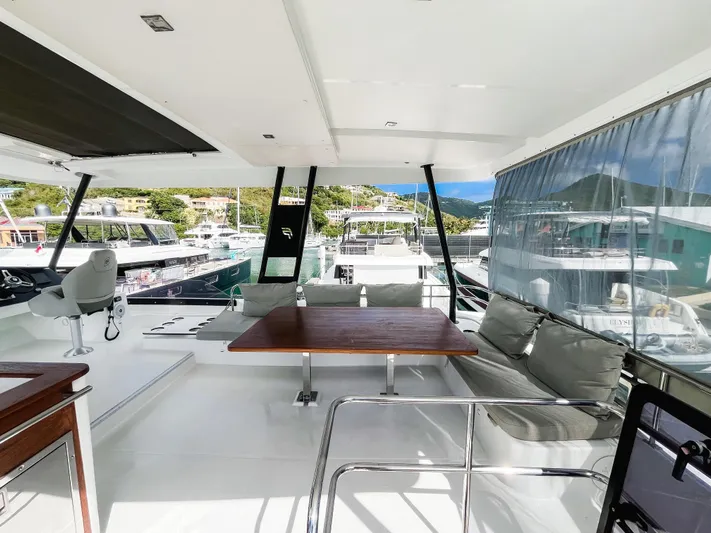 Wild Blue Yacht Photos Pics 2019 Fountaine Pajot MY 44 yacht interior with seating and table, docked at marina.
