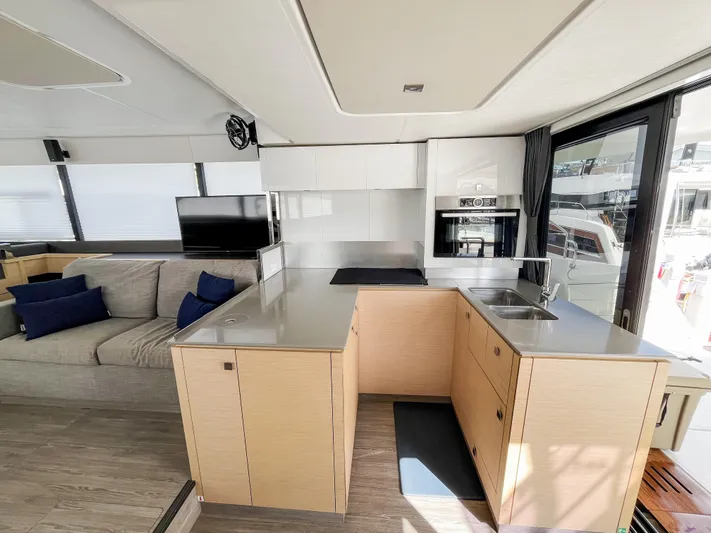 Wild Blue Yacht Photos Pics Modern interior of 2019 Fountaine Pajot MY 44 yacht with sleek kitchen and cozy seating area.