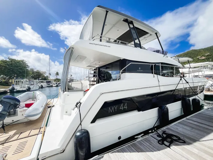 Wild Blue Yacht Photos Pics Luxury 2019 Fountaine Pajot MY 44 yacht docked at marina under blue sky.