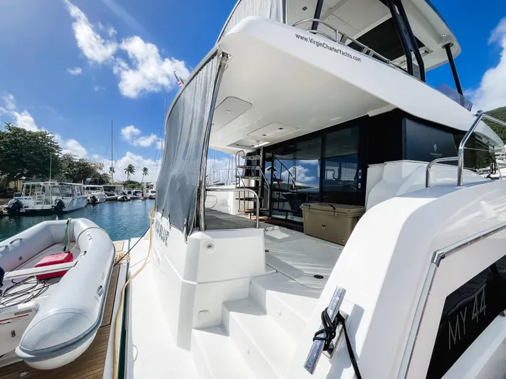 Wild Blue Yacht Photos Pics 2019 Fountaine Pajot MY 44 yacht docked, featuring spacious deck and inflatable boat.