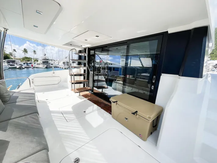 Wild Blue Yacht Photos Pics 2019 Fountaine Pajot MY 44 yacht deck with seating, stairs, and marina view.