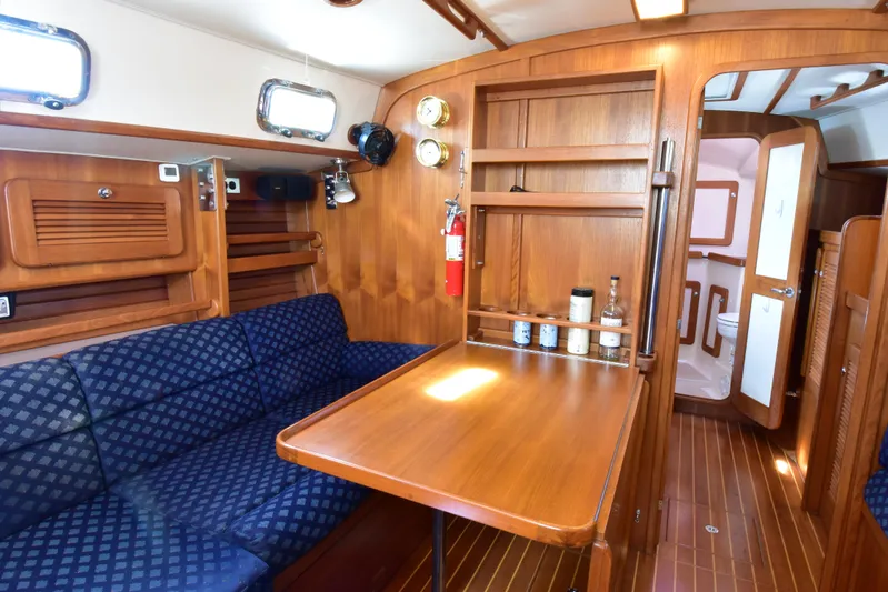 Jellyfish Problems Yacht Photos Pics Interior of 2008 Caliber 40 LRC SE yacht with wooden furnishings and blue seating.