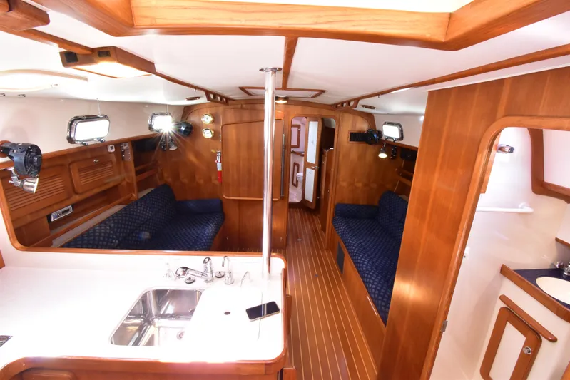 Jellyfish Problems Yacht Photos Pics Interior of 2008 Caliber 40 LRC SE yacht with wood finish and blue seating.