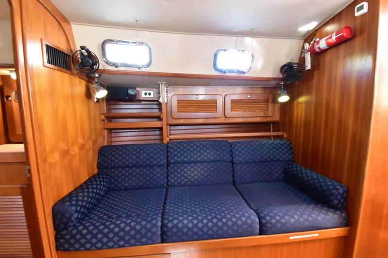 Jellyfish Problems Yacht Photos Pics Interior of 2008 Caliber 40 LRC SE yacht with blue cushioned seating and wooden paneling.