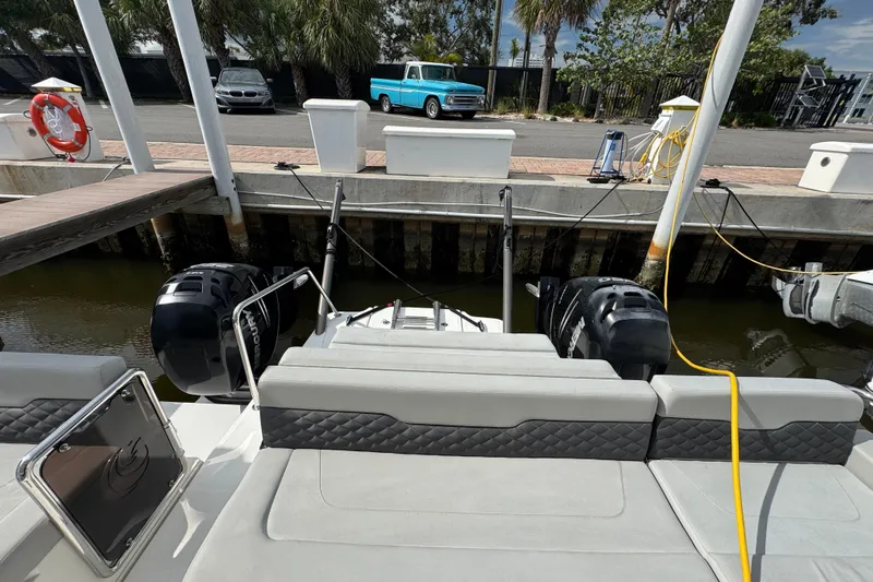  Yacht Photos Pics Aquila 36 Sport 2020 docked, featuring dual outboard engines and a spacious seating area.