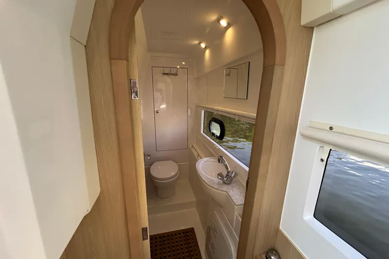  Yacht Photos Pics Bathroom interior of 2020 Aquila 36 Sport yacht, featuring modern fixtures and window view.