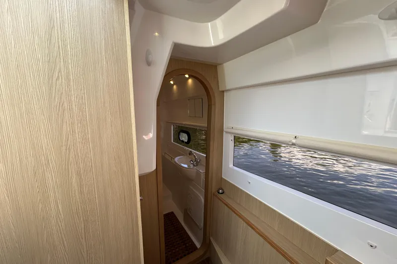  Yacht Photos Pics Interior of 2020 Aquila 36 Sport boat, featuring wood paneling and a compact bathroom.