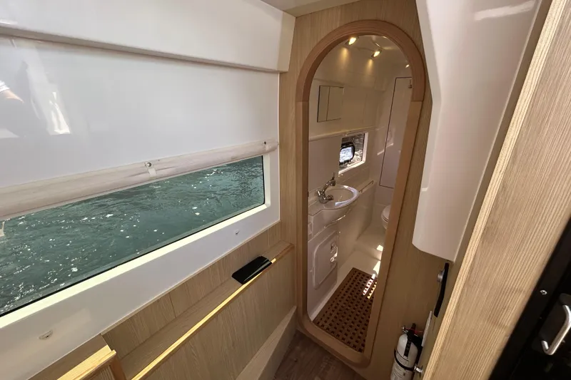  Yacht Photos Pics Interior of 2020 Aquila 36 Sport yacht, featuring a modern bathroom and window view.