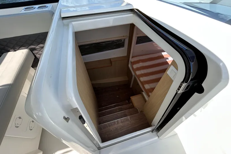  Yacht Photos Pics Interior view of 2020 Aquila 36 Sport boat cabin entrance with wooden stairs.