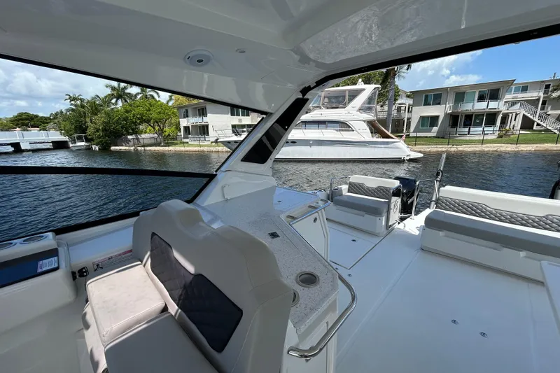  Yacht Photos Pics Interior view of 2020 Aquila 36 Sport yacht docked by waterfront homes.