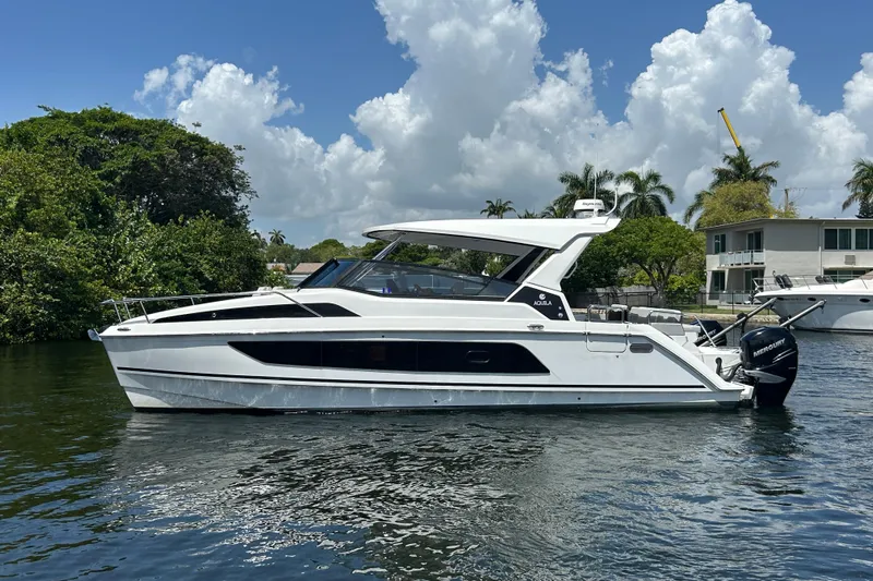  Yacht Photos Pics Aquila 36 Sport 2020 boat cruising on a sunny day with lush greenery background.