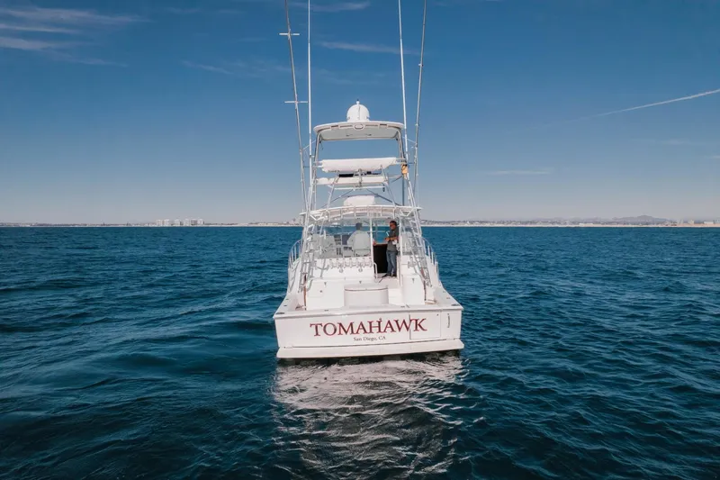 Tomahawk Yacht Photos Pics 2008 Cabo 40 Express boat named "Tomahawk" on open sea, clear sky background.