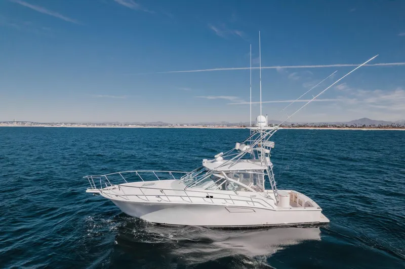 Tomahawk Yacht Photos Pics 2008 Cabo 40 Express yacht cruising on open sea under clear blue sky.
