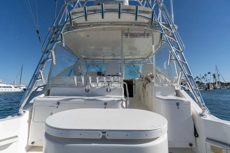 Tomahawk Yacht Photos Pics 2008 Cabo 40 Express yacht with spacious deck and fishing equipment, docked in a marina.