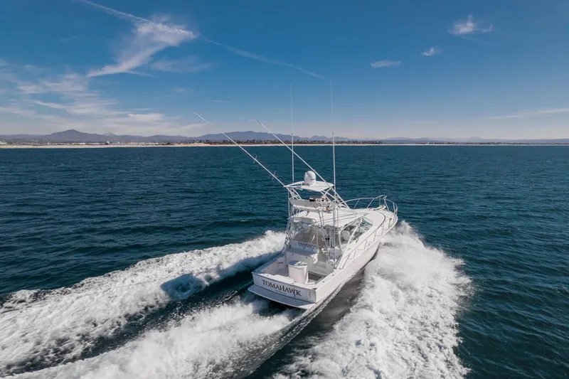 Tomahawk Yacht Photos Pics 2008 Cabo 40 Express boat cruising on open water under clear blue sky.