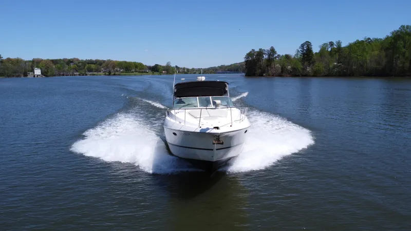  Yacht Photos Pics 2004 Cruisers Yachts 370 Express cruising on a scenic lake.