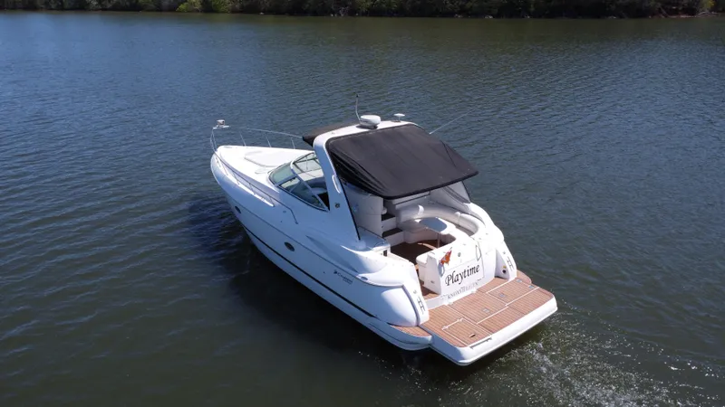  Yacht Photos Pics 2004 Cruisers Yachts 370 Express on calm water, featuring sleek design and spacious deck.