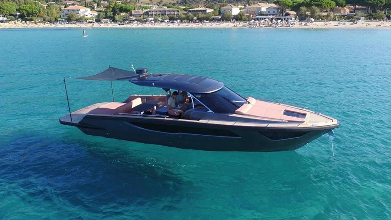 2023 Focus Forza 37 yacht cruising on clear blue water near a scenic coastline.