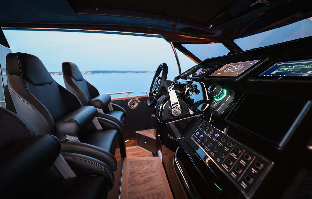Luxurious 2023 Focus Forza 37 yacht cockpit with advanced controls and leather seating.