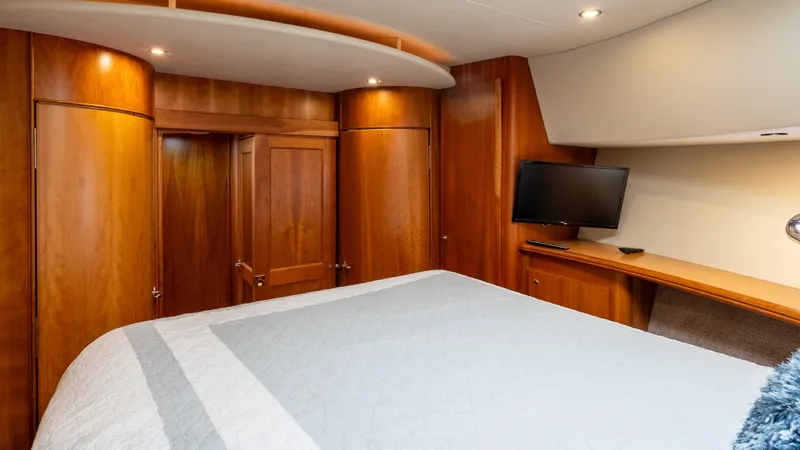  Yacht Photos Pics Luxurious cabin interior of 2002 Silverton 41 Sport Bridge yacht with wood paneling and TV.