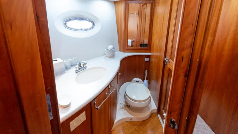  Yacht Photos Pics Luxurious bathroom in 2002 Silverton 41 Sport Bridge yacht with wooden cabinetry and modern fixtures.