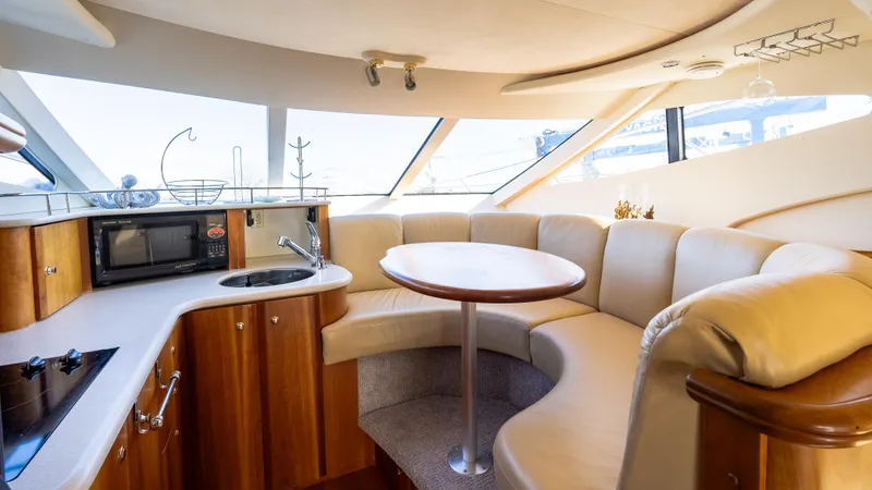  Yacht Photos Pics Luxurious interior of 2002 Silverton 41 Sport Bridge yacht with modern kitchen and seating area.