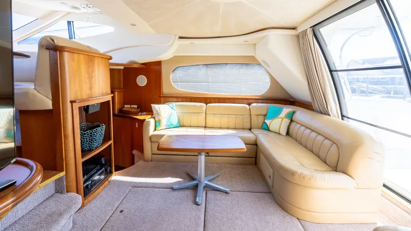  Yacht Photos Pics Luxurious interior of a 2002 Silverton 41 Sport Bridge yacht with plush seating and wooden accents.