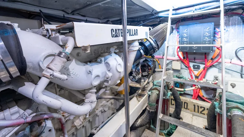  Yacht Photos Pics Engine room of 2002 Silverton 41 Sport Bridge with Caterpillar engine and control panel.