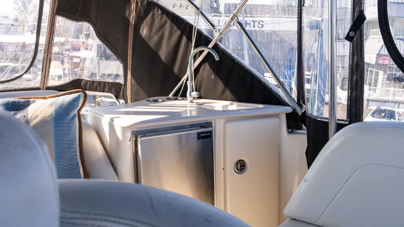  Yacht Photos Pics Interior view of a 2002 Silverton 41 Sport Bridge yacht with seating and kitchenette.