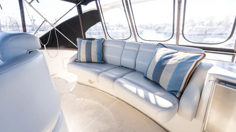  Yacht Photos Pics Luxurious interior of 2002 Silverton 41 Sport Bridge with plush seating and striped cushions.