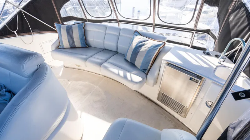  Yacht Photos Pics 2002 Silverton 41 Sport Bridge interior with plush seating and striped cushions.