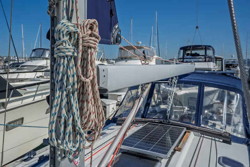 "champagne" Yacht Photos Pics Jeanneau Sun Odyssey 45.2 sailboat, 2003 model, with ropes and solar panel in marina.