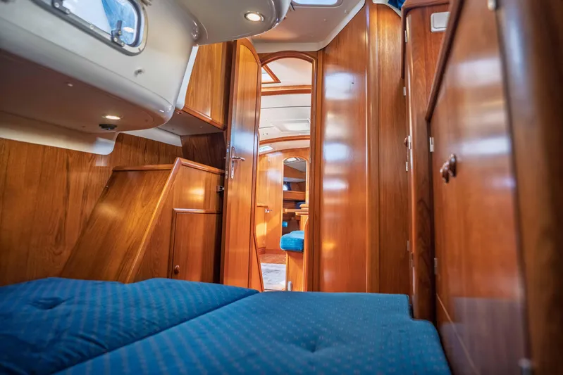 "champagne" Yacht Photos Pics Interior of 2003 Jeanneau Sun Odyssey 45.2 yacht with wooden finish and blue upholstery.