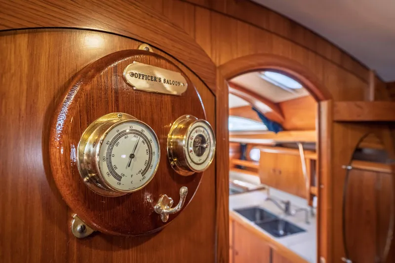"champagne" Yacht Photos Pics Interior of 2003 Jeanneau Sun Odyssey 45.2 yacht with classic wooden design and barometer.