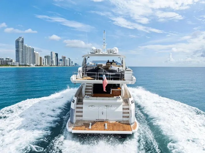 Deep Blue Yacht Photos Pics Azimut Flybridge 2018 yacht cruising near city skyline on a sunny day.