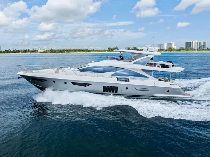 Deep Blue Yacht Photos Pics 2018 Azimut Flybridge yacht cruising on open water under a clear blue sky.