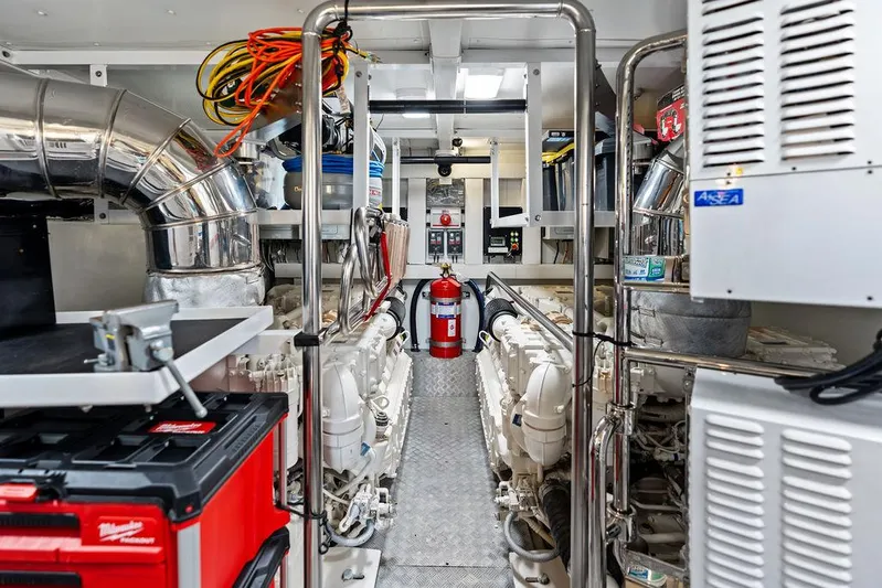 Deep Blue Yacht Photos Pics Engine room of 2018 Azimut Flybridge yacht with equipment and fire extinguisher.