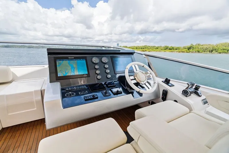 Deep Blue Yacht Photos Pics 2018 Azimut Flybridge yacht helm with navigation screens and steering wheel.