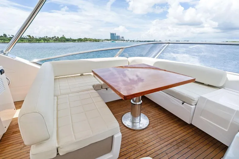 Deep Blue Yacht Photos Pics Luxurious 2018 Azimut Flybridge yacht with elegant seating and wooden table on deck.