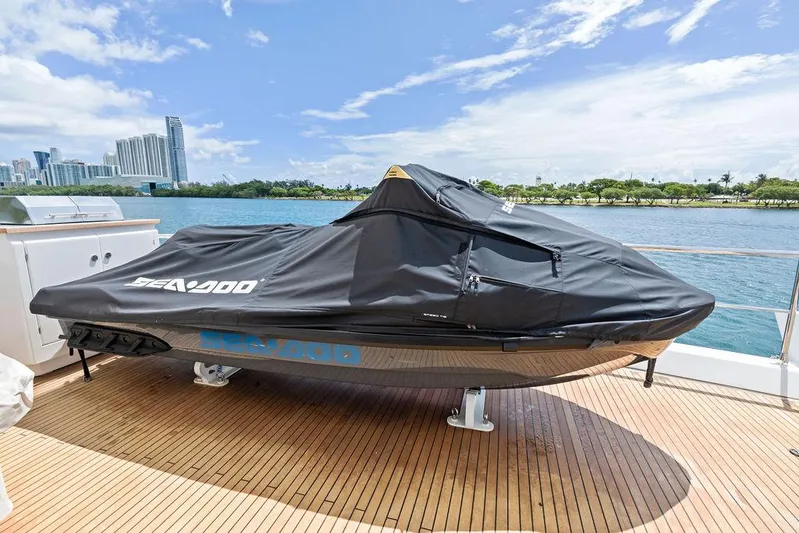 Deep Blue Yacht Photos Pics Jet ski covered on Azimut Flybridge yacht deck, city skyline in background.