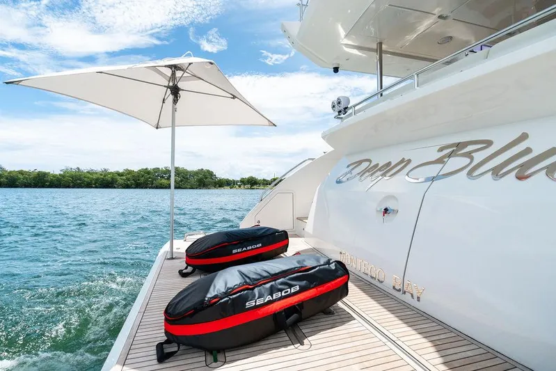 Deep Blue Yacht Photos Pics 2018 Azimut Flybridge yacht deck with Seabob equipment and umbrella on a sunny day.