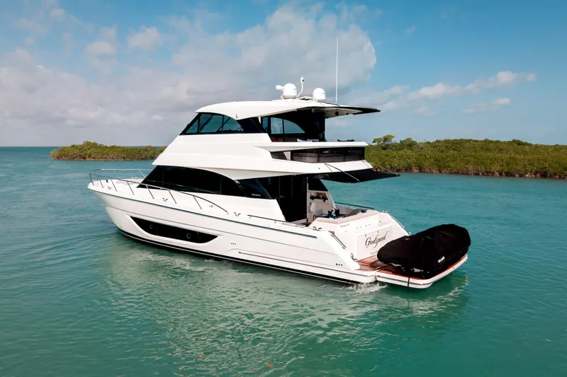 Godspeed Yacht Photos Pics 2024 Maritimo M55 yacht cruising in clear blue waters under a sunny sky.