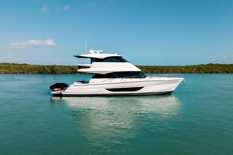 Godspeed Yacht Photos Pics 2024 Maritimo M55 yacht cruising on serene blue waters under clear skies.