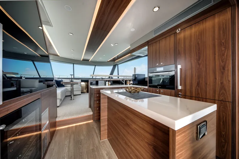 Godspeed Yacht Photos Pics Luxurious interior of 2024 Maritimo M55 yacht with modern kitchen and panoramic windows.